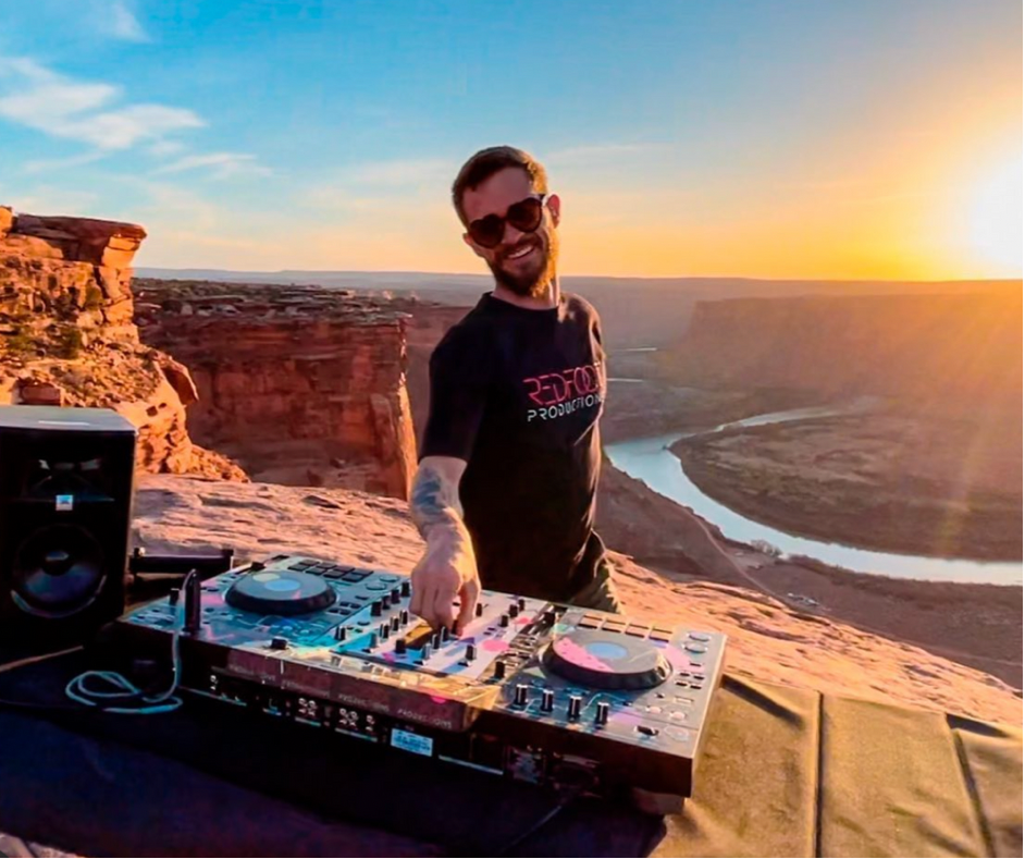 Picture of DJ smiling with sun in the background